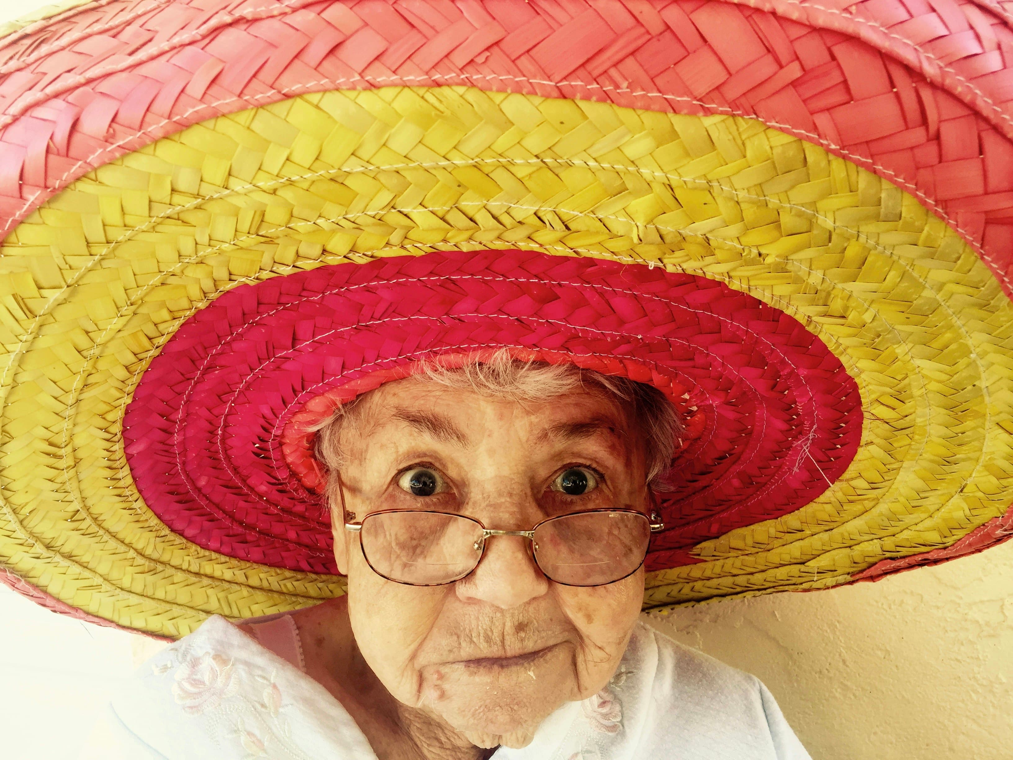 A kind elderly person smiling warmly in the sun